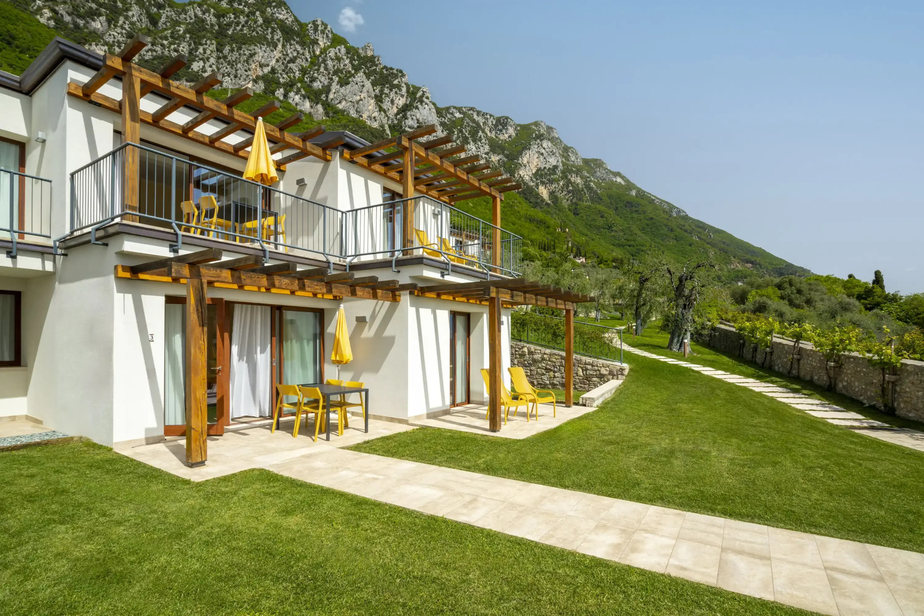 Modern apartments with pergolas, mountain view and manicured lawn